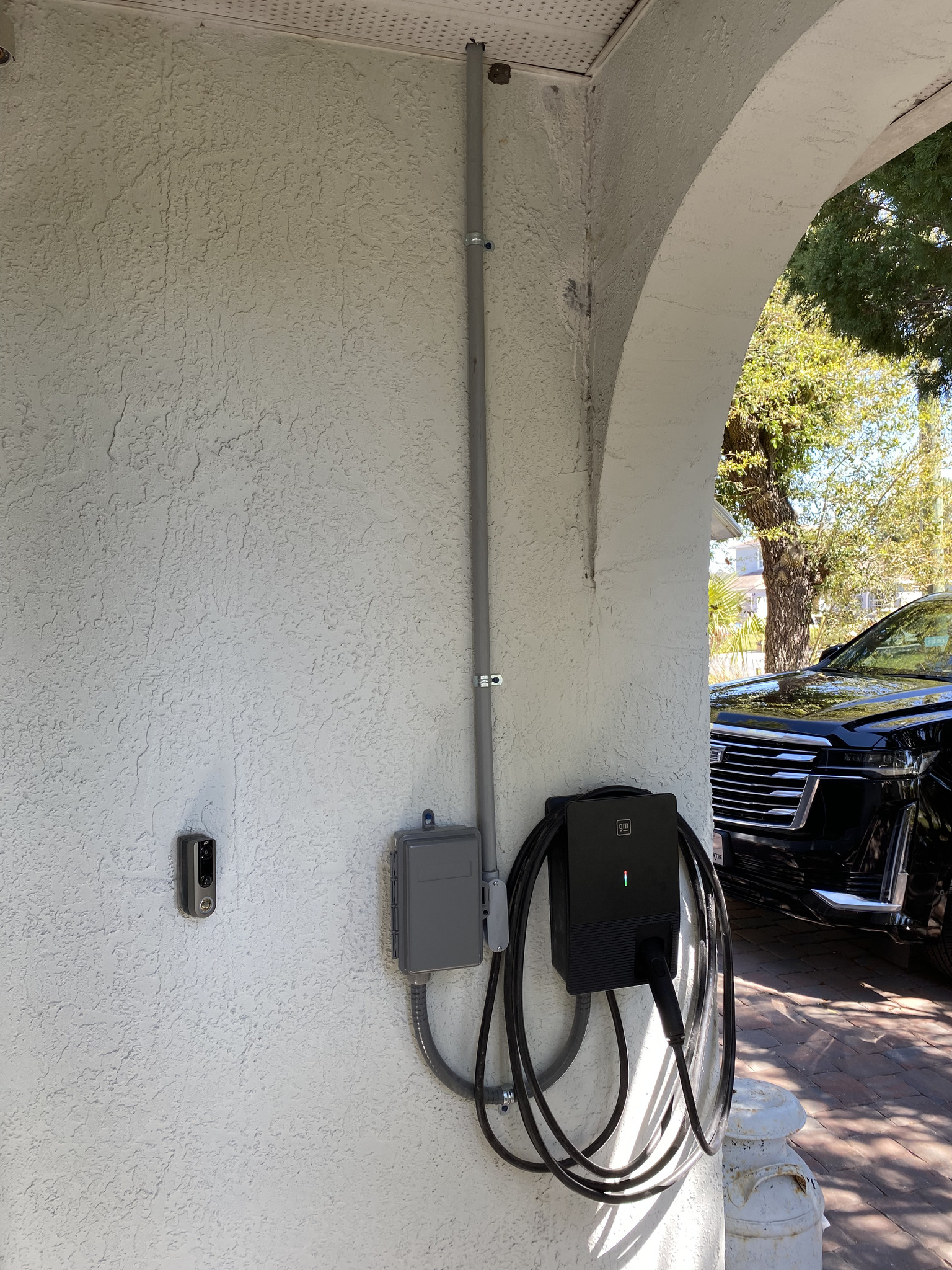 GM Level 2 EV charger installed on a wall, wired and ready for home charging.