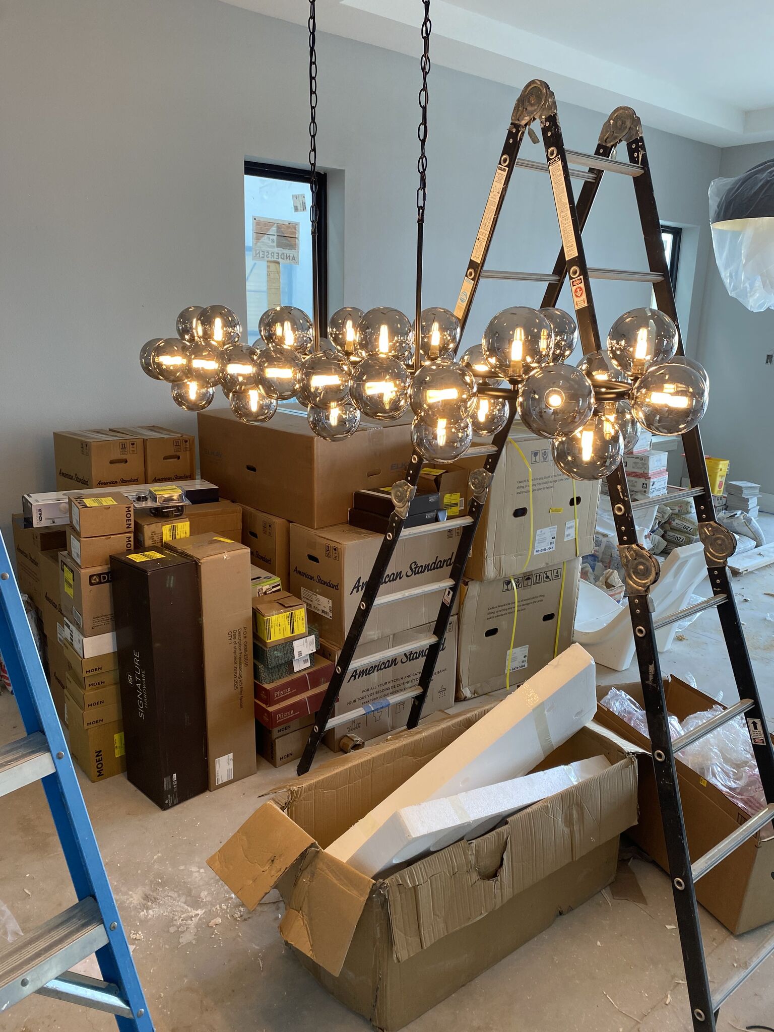 Room ceiling with evenly spaced recessed LED downlights switched on.