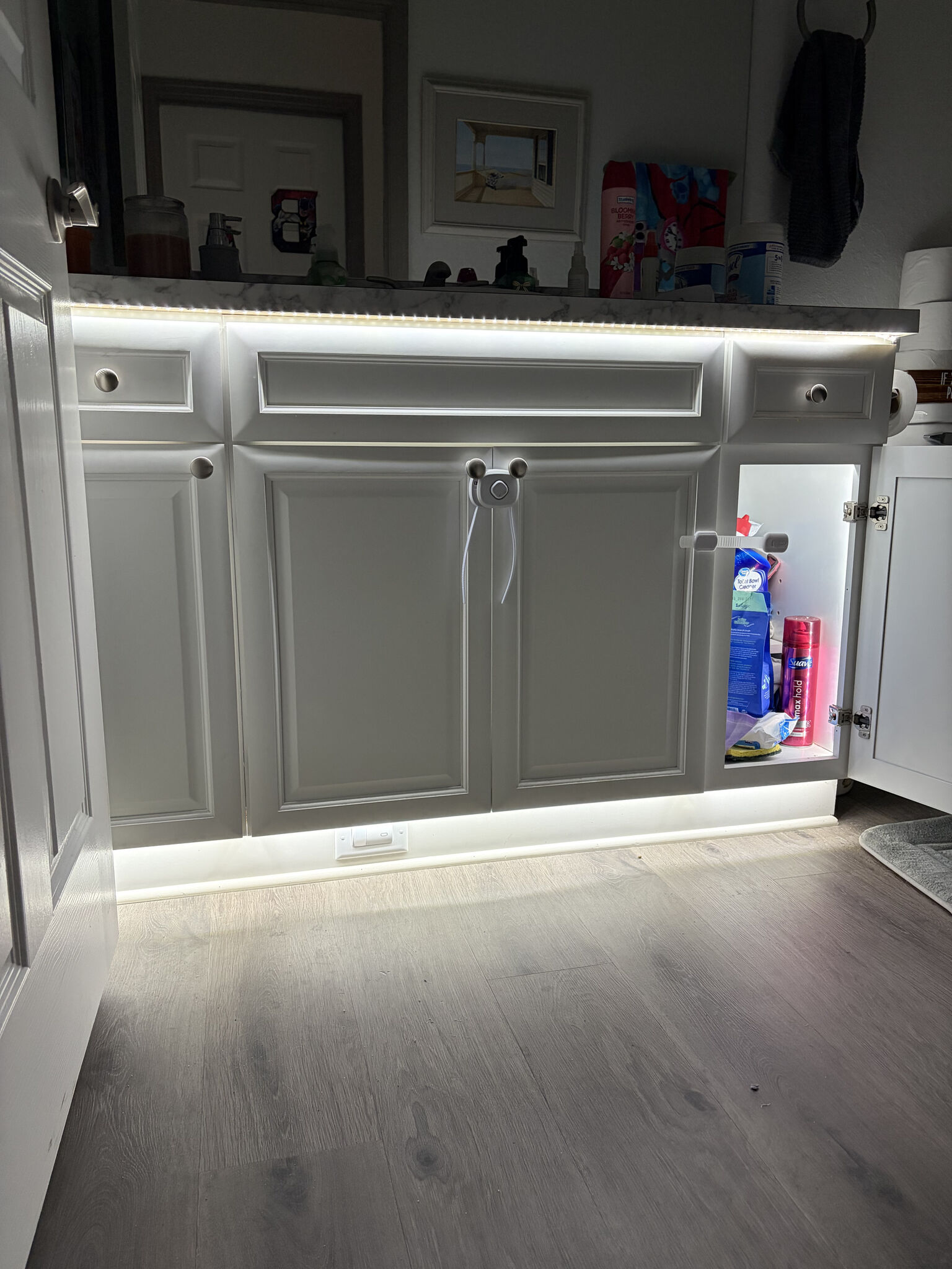 Concealed LED strip lighting glowing under a counter edge.